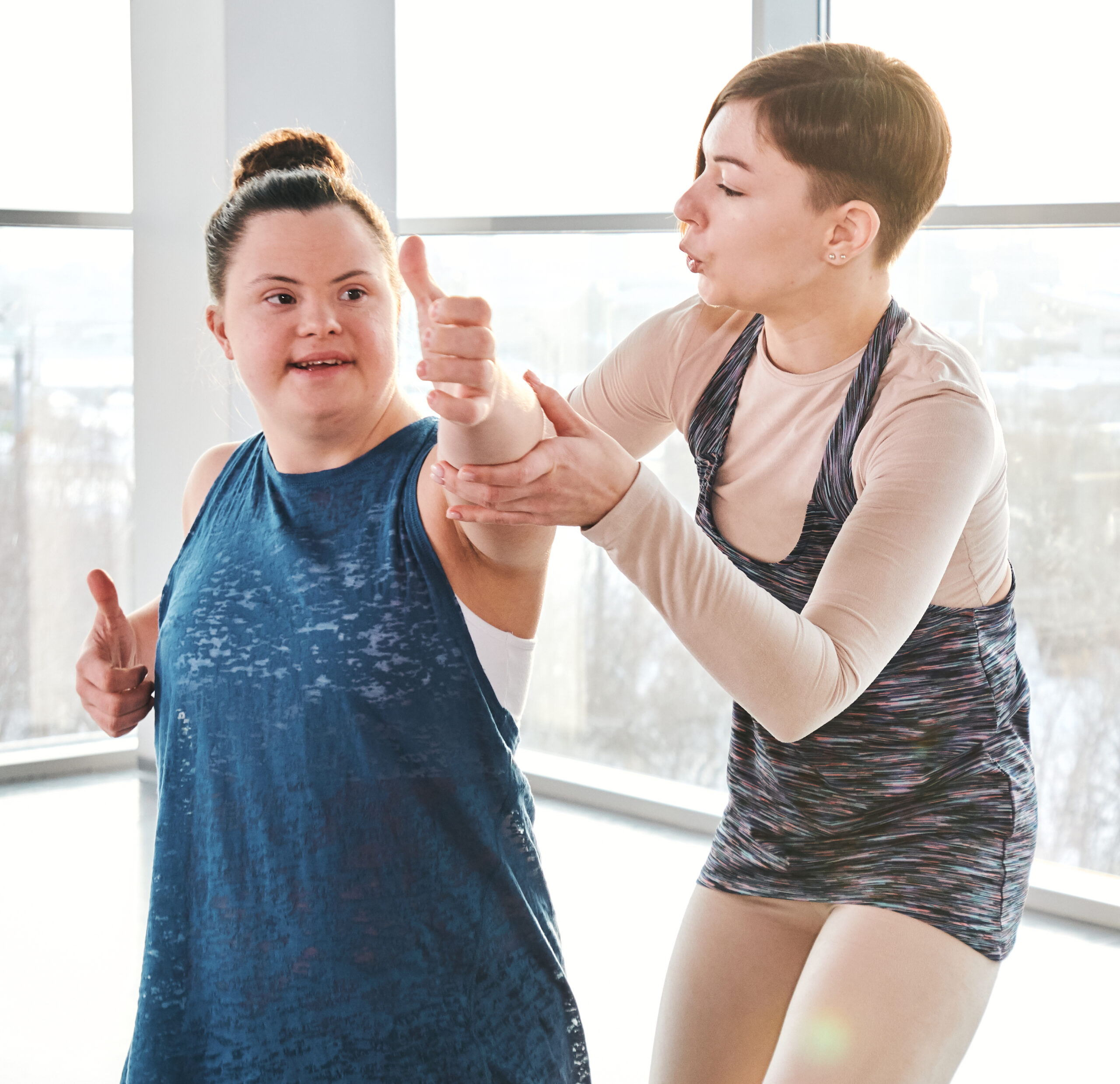 Young,Yoga,And,Fitness,Trainer,In,Activewear,Standing,By,Disable